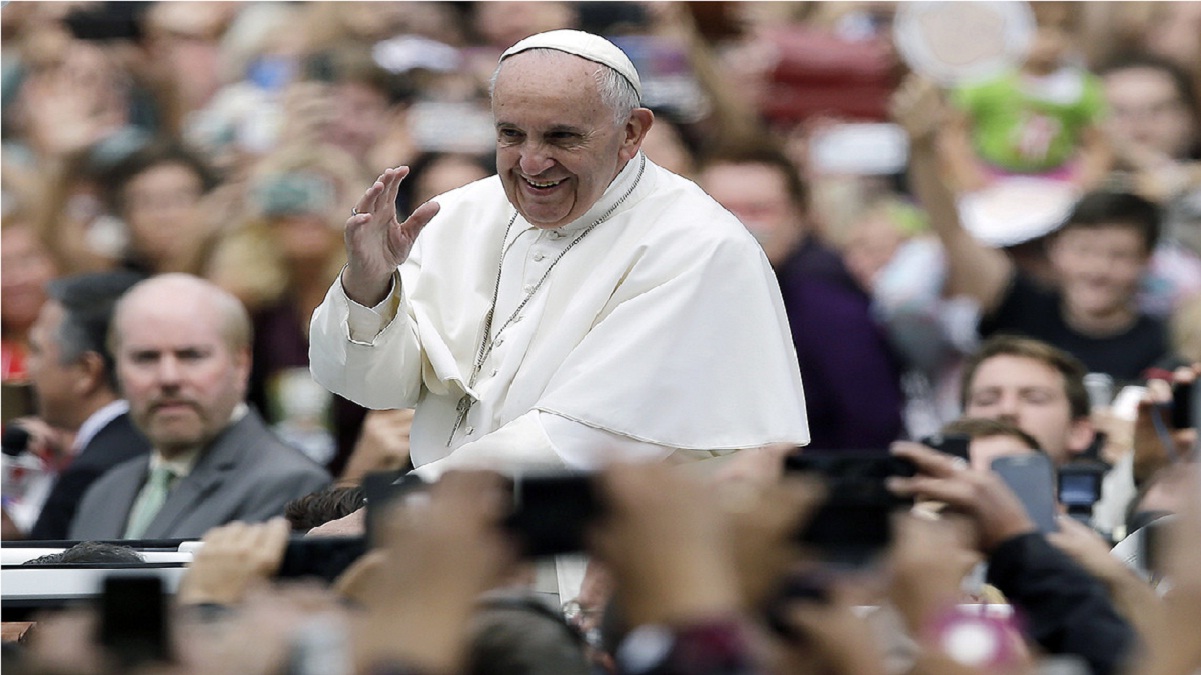 Pope Francis waves as he travels to a Sunday Mass in 2015 in Philadelphia. | Matt Rourke/AP Photo/Pool