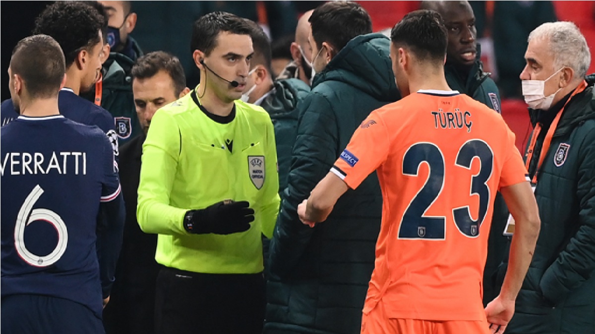 Romanian referee Ovidiu Hategan (in yellow) talks to Istanbul Basaksehir’s staff members past Istanbul Basaksehir’s French forward Demba Ba (2ndR) after the game was suspended amid allegations of racism by one of the match officials during the UEFA Champions League group H football match between Paris Saint-Germain (PSG) and Istanbul Basaksehir FK at the Parc des Princes stadium in Paris, on December 8, 2020. FRANCK FIFE / AFP