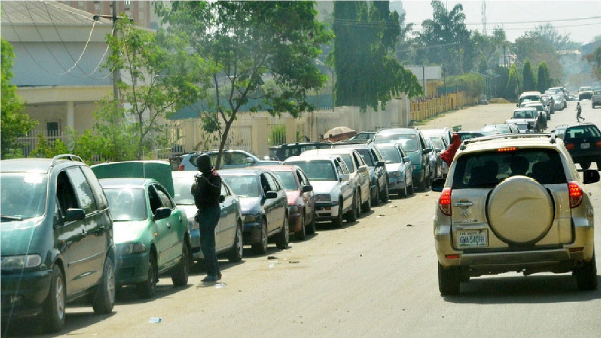 Motorists form long queues to get fuel from a filling station